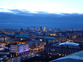 High angle view of illuminated buildings in city at dusk