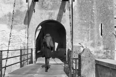 Full length rear view of woman entering fort