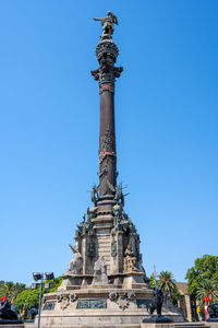 Low angle view of statue against blue sky