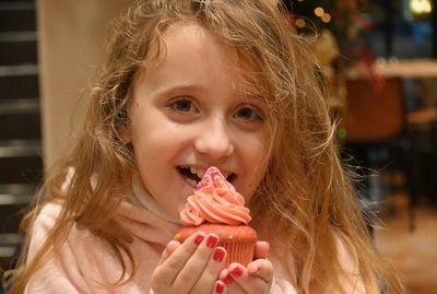 Portrait of girl eating cupcake