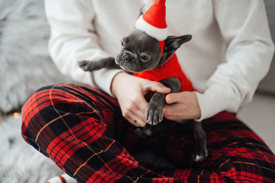 Midsection of man holding dog