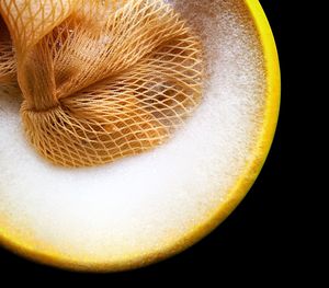 High angle view of lemon slice over black background