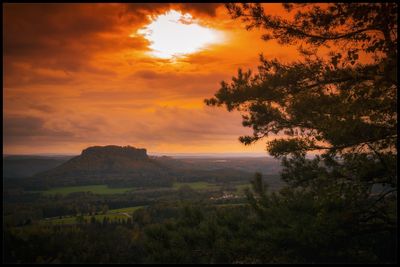 Scenic view of field against sky during sunset