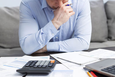 Midsection of businessman working at desk in office