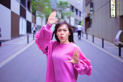 Full length of woman standing on street in city