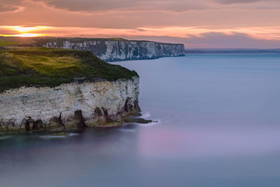 Scenic view of sea against sky at sunset