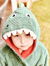 Portrait of boy wearing bathrobe outdoors