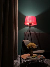 Close-up of illuminated lamp on table at home