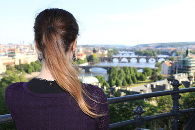 Rear view of woman looking at cityscape