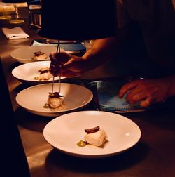 High angle view of hand holding ice cream on table
