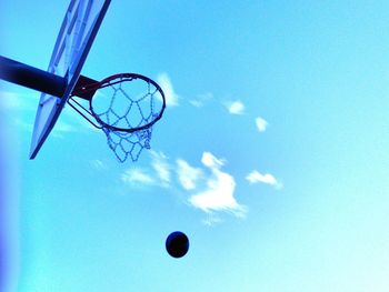 Low angle view of basketball hoop against blue sky