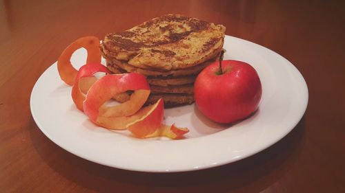 Pancakes and apple served in plate