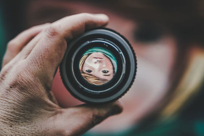 Close-up of woman holding camera