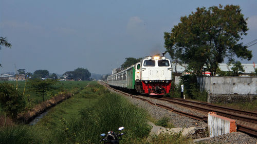 Train on railroad track against sky