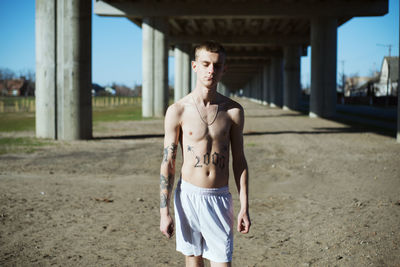 Shirtless young man outdoors