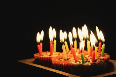 Close-up of burning candles on table