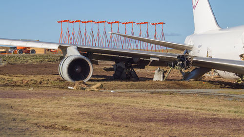 Airplane on field against sky