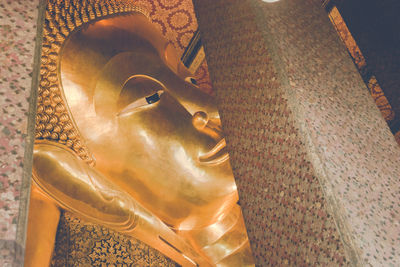 Close-up of buddha statue against building