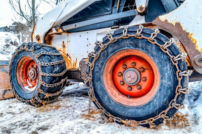 Old rusty car on snow covered land