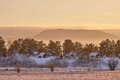 Scenic view of snowcapped mountains against sky during sunset
