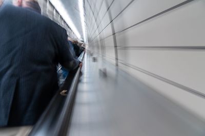 Woman standing on escalator