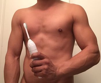 Midsection of shirtless man