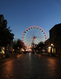 Ferris wheel in city at night