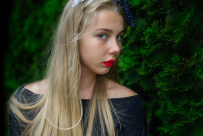 Portrait of beautiful young woman looking away