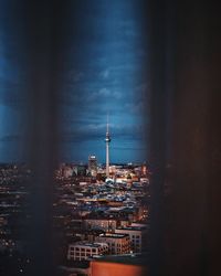 Illuminated cityscape against sky