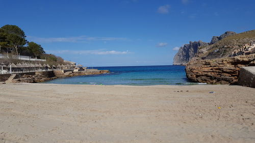 Scenic view of beach against cloudy sky