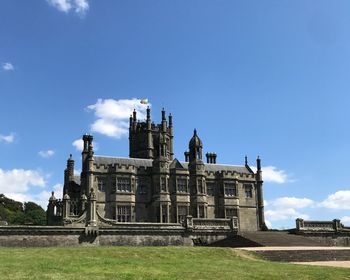 Low angle view of historic building against blue sky