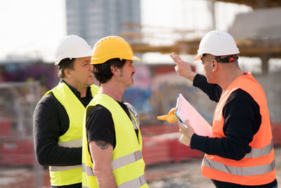 Coworkers working at construction site