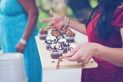 Midsection of woman playing with food on table