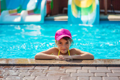 Portrait of girl wearing cap in swimming pool