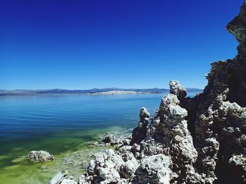 Scenic view of sea against clear blue sky