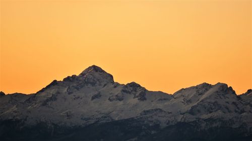 Scenic view of mountains against clear sky during sunset