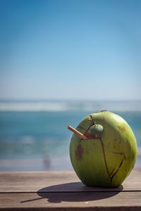 Coconut with a tube on the windowsill. ocean view. coconut water drink.