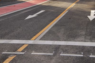 High angle view of arrow symbol on road in city