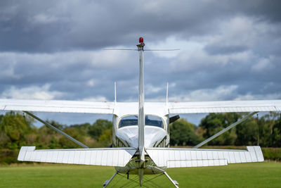 Airplane on airport runway against sky