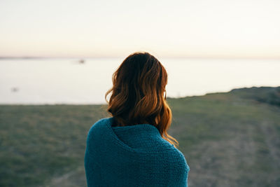 Rear view of woman looking at sea against sky