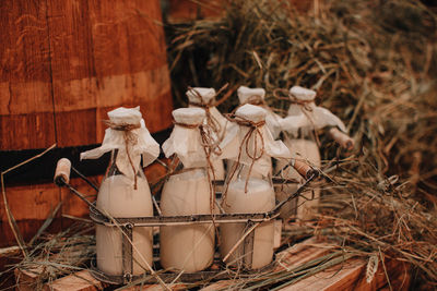 Milk bottles mockups on the hay. autumn farm fair market. rustic style. thanksgiving season. 