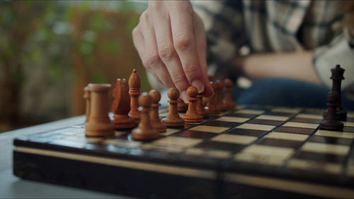 Cropped hand playing chess