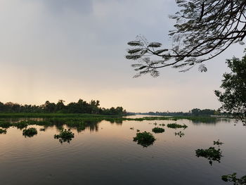 Scenic view of lake against sky at sunset