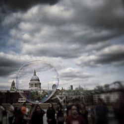 Buildings against cloudy sky