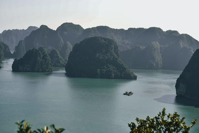 Scenic view of sea and mountains against sky