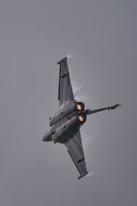 Low angle view of airplane flying against clear sky