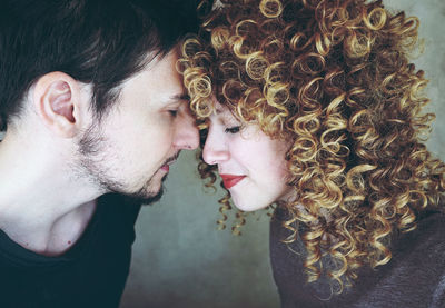 Couple romancing against wall