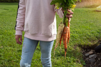 Midsection of man holding ice cream cone