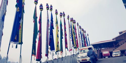 Low angle view of flags hanging against clear sky