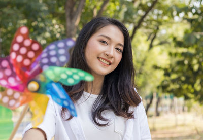 Beautiful asian women playing turbines in the park happily. concept of living a happy holiday